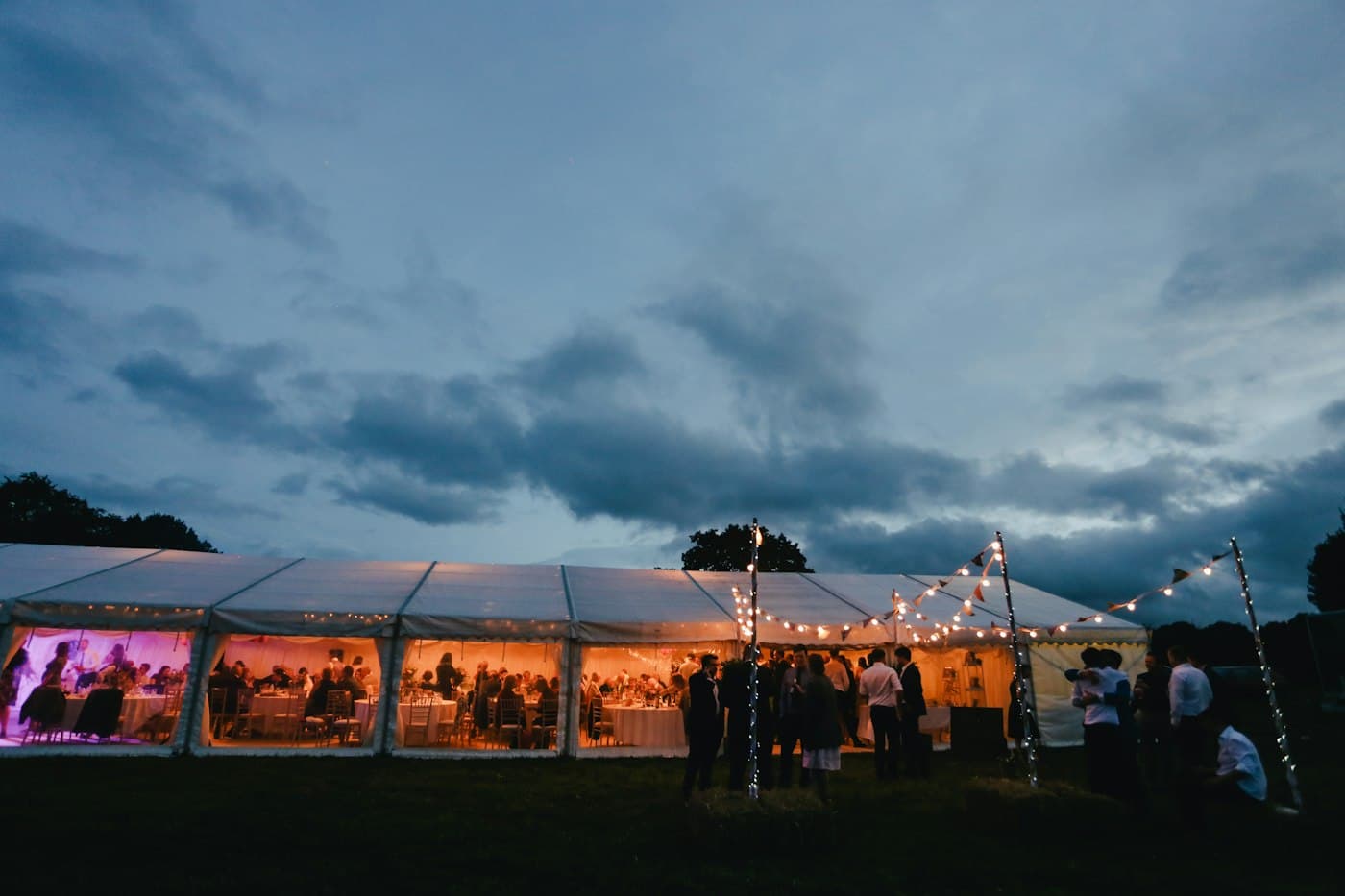 Lit marquee under string lights at dusk