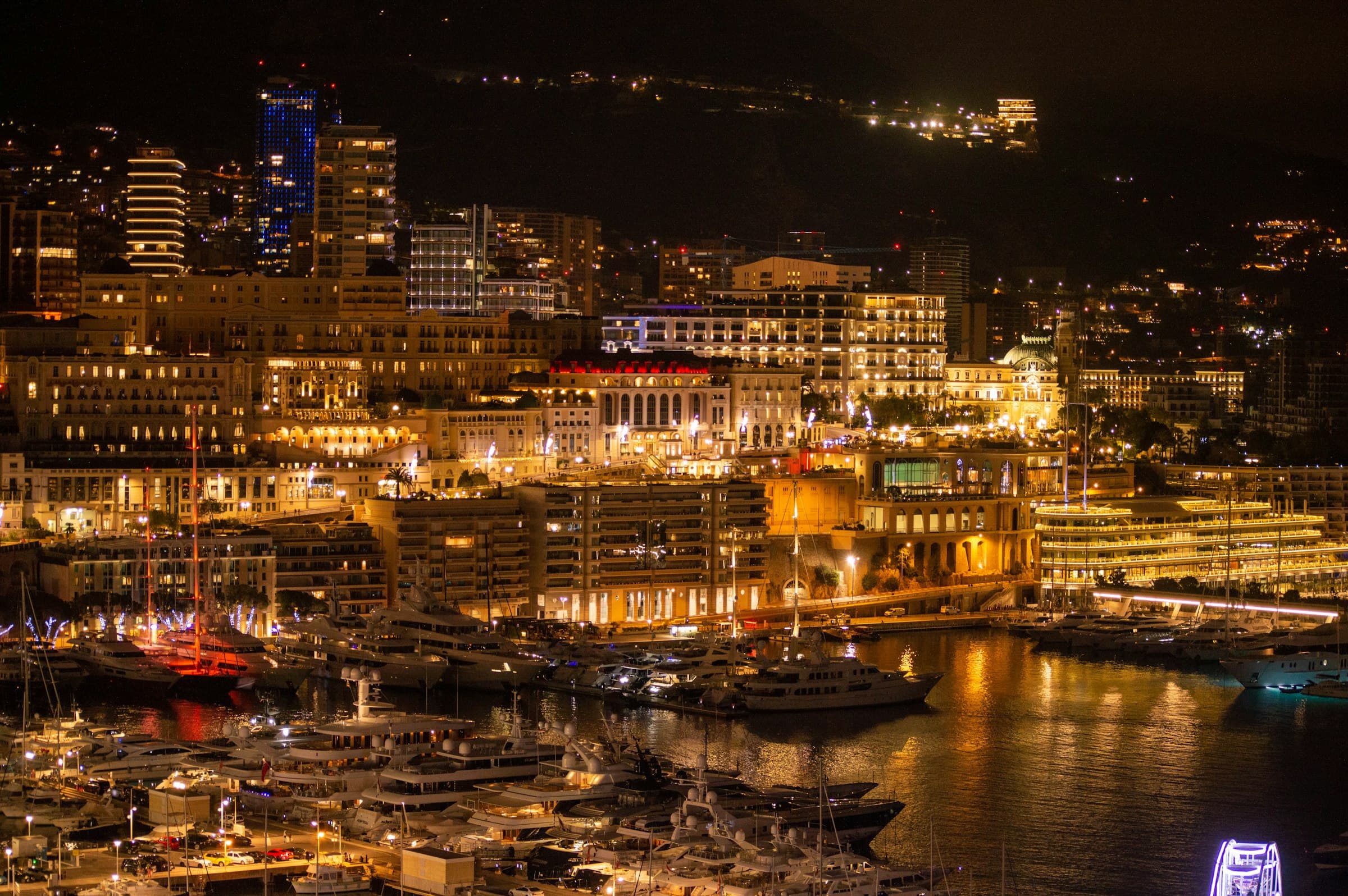 Monaco harbour at night, yachts beneath the lights of the city